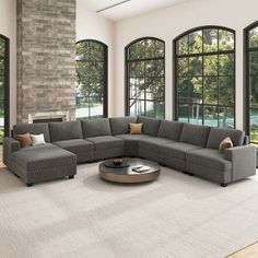 a living room with large windows and a sectional couch