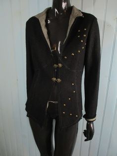 Vintage wool jacket. Black with two unusual clasps and scattered metal studs across the front.  Good condition. Dimensions: Bust: 38 Inches. Length: 23 Inches. Sleeve: 18 Inches. Made in France Fitted Winter Outerwear With Studs, Winter Fitted Studded Outerwear, Fitted Studded Winter Outerwear, Studded Winter Outerwear, Gothic Winter Outerwear With Studs, Gothic Studded Winter Outerwear, Gothic Studded Outerwear For Winter, Studded Long Sleeve Winter Outerwear, Vintage Jackets Retro