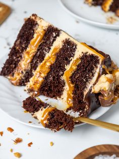 a slice of chocolate cake with caramel drizzled on top and peanut butter frosting