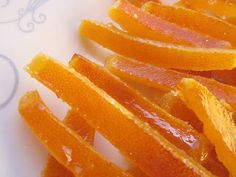 peeled oranges on a white plate sitting on a table