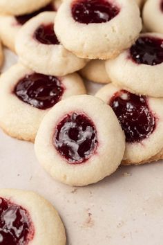 several cookies with jam on them sitting on a table