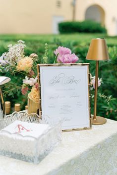 a table with flowers and a sign on it