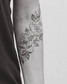 a woman's arm with flowers on it and the words temporary tattoos written in black ink