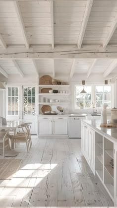 an open kitchen with white cabinets and wood flooring is pictured in this image from the inside