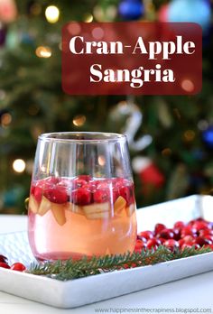 cran - apple sanggraa in a wine glass on a tray