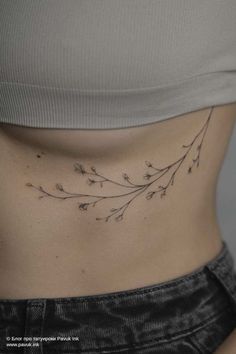 a woman's stomach with small flowers on it