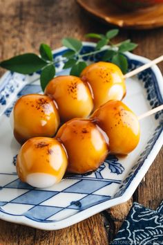 some food is on a blue and white plate with green leaves in the background,