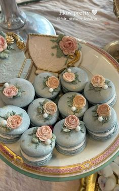 there are many blue and pink cupcakes on the plate in the shape of a carriage