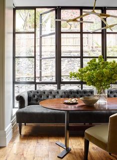 a living room filled with furniture and lots of window sill space next to a couch