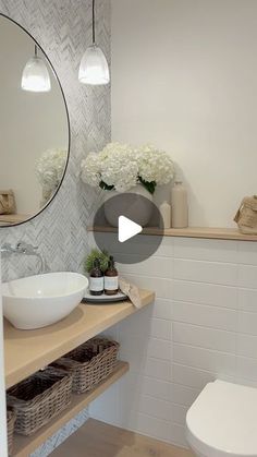 a bathroom with a sink, toilet and mirror in it's centerpieces