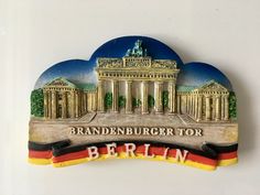 a wooden sign with the name berlin in front of a building and german flag on it