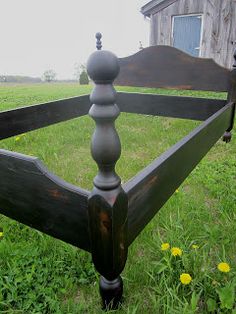 an old wooden bed frame in the grass