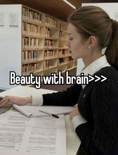 a woman sitting at a desk with a laptop computer in front of her and the words beauty with brain > >