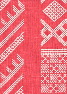 a red and white knitted pattern with different designs on the side, including two hearts