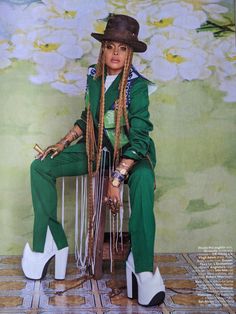 a woman sitting on top of a wooden chair wearing green pants and white high heels