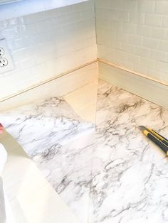 a marble counter top with a knife on it