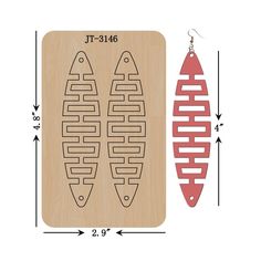 a pair of earrings is shown next to a laser cut pattern on a wooden board