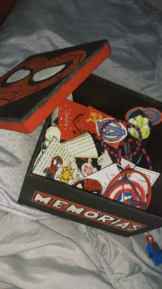 a spiderman themed box on a bed