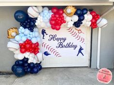 a baseball themed birthday party with balloons and streamers on the front door to celebrate someone's first birthday