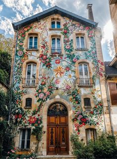 an old building with flowers painted on it