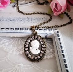 Antique inspired necklace features cameo pendant of white Victorian lady on opalescent background. The resin cameo is accented with rhinestone trim and set on antiqued bronze bezel. It suspended from a brass chain. A beautifully sweet piece for yourself or a loved one!! Pendant dimension: Approx. 30*20 mm. Please convo me for free chain length not on the list. Purchase over $40 enjoys free shipping! Coupon code 'freeshipping1'. Free Gift Wrapping on request - All items that are gift wrapped come Small Drop Earrings, Cameo Pendant Necklace, White Victorian, Inspired Necklace, Victorian Lady, Cameo Necklace, Rhinestone Trim, Cameo Pendant, Jewelry Antique