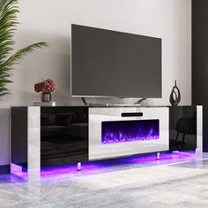 a living room with a large television and purple flames on the fireplace in front of it