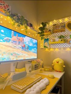 a desk with a computer monitor, keyboard and mouse on it in front of a yellow wall