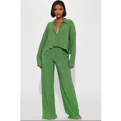 Green Plisse Co Ord Set Featuring Long Sleeve Collared Shirt With Button Front And Matching Wide Leg Elastic Waist Pants With Metallic Details Material: 77% Polyester | 17% Metallic | 6 % Spandex Measurements: " Length Casual Spring Button-up Pant Set, Spring Casual Button-up Pant Set, Spring Button-up Loungewear Pants, Casual Green Button-up Pants, Spring Green Button-up Pants, Trendy Button-up Loungewear Bottoms, Casual Pants With Button Closure For Night Out, Chic Loungewear Pants With Button Closure, Casual Green Long Sleeve Pantsuit