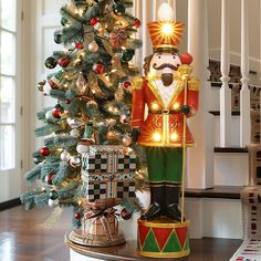 a nutcracker statue next to a christmas tree