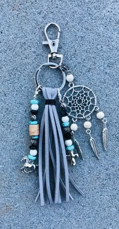 a tasseled keychain with beads and charms hanging from it's side