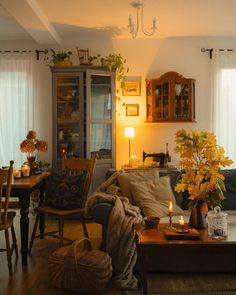 a living room filled with furniture and lots of flowers on top of a wooden table