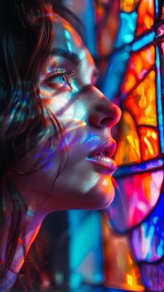 a woman with her eyes closed looking at the stained glass window behind her is an artistic image