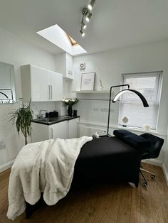 a black and white bed in a small room