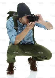 a man kneeling down with a camera in his hand royalty photo