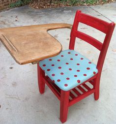 a red chair with a blue polka dot seat and wooden cutting board attached to it