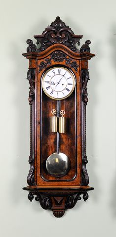 an old wooden clock hanging on the wall