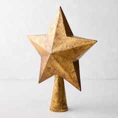 a wooden star shaped object on a white surface