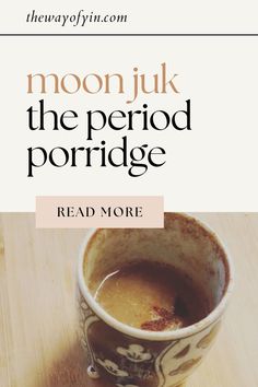 a cup of coffee sitting on top of a wooden table next to a book titled moonjuk the period porridge