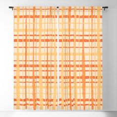 an orange and white plaid pattern sheer curtain