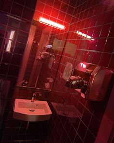 a bathroom with a sink, mirror and toilet paper dispenser in it