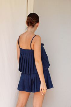 Color: Denim Pleated set Front bow top Button down shorts Model wears size small 74% Polyester 22% Viscose 4% Rayon Blue Short-length Top For Summer, Chic Short Blue Tops, Summer Ruffled Short Tops, Short Models, Home Outfit, Dress Pants, Skirt Pants, Outfit Sets, Dresses