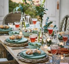 the table is set with plates and glasses