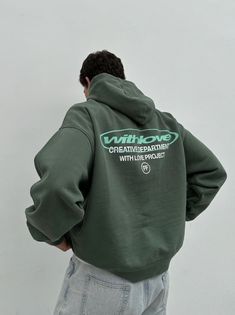 a man wearing a green hoodie with the words whitkone on it