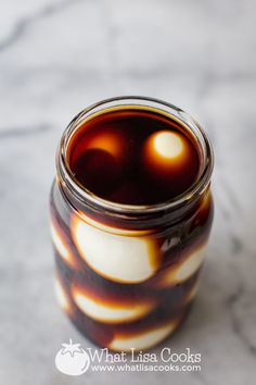 a jar filled with liquid sitting on top of a table