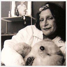 an old photo of a woman holding a cat