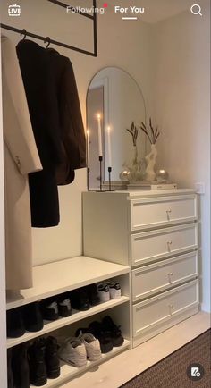 a white dresser sitting next to a closet filled with shoes