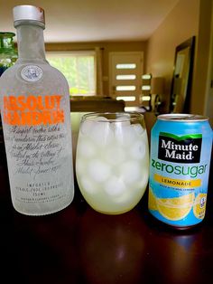 a bottle of lemonade next to a can of absolut marron and a glass filled with ice