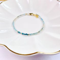 Elevate your style with our dainty Apatite bracelet, crafted with delicate 2mm cube gemstones. This nature gemstone jewelry offers minimalistic charm and crystal healing protection. Give the gift of love and positive energy to your loved ones today! Add a touch of elegance to your look with our delicate 2mm cube gemstone bead bracelet featuring dainty Apatite stones. Embrace the beauty of nature with this minimalist jewelry piece, offering crystal healing properties and protection. The perfect g Handmade Dainty Rondelle Beaded Bracelets, Dainty Handmade Rondelle Beaded Bracelets, Dainty Blue Gemstone Beaded Bracelets, Blue Dainty Gemstone Beaded Bracelet, Delicate Adjustable Gemstone Beaded Bracelets, Apatite Bracelet, Jewelry Nature, Apatite Stone, Crystals Healing Properties