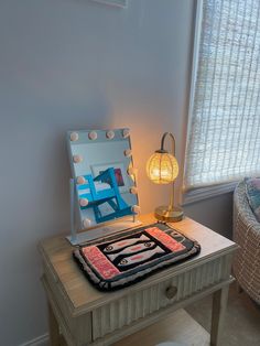 a table with a mirror and lamp on it