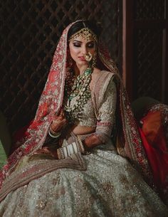 a woman wearing a bridal outfit and jewelry